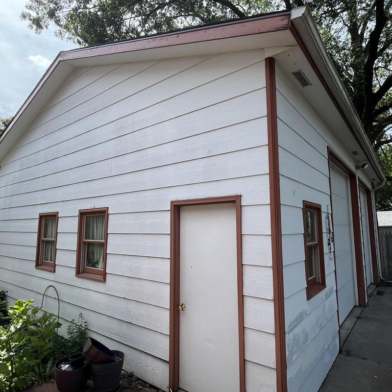 Garage siding with brown trim and white panels Garage siding with brown trim and white panels
