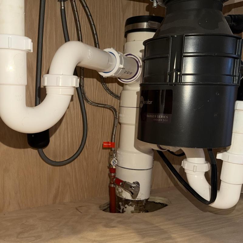 Garbage disposal air switch and plumbing pipes under sink