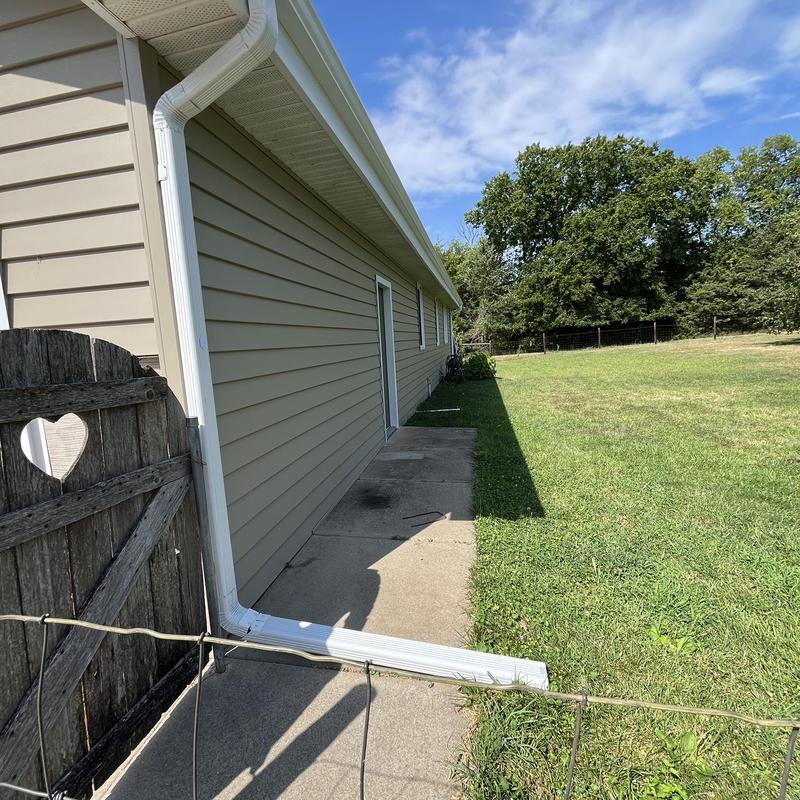 Mastic aluminum gutter coils on beige house exterior Mastic aluminum gutter coils on beige house exterior