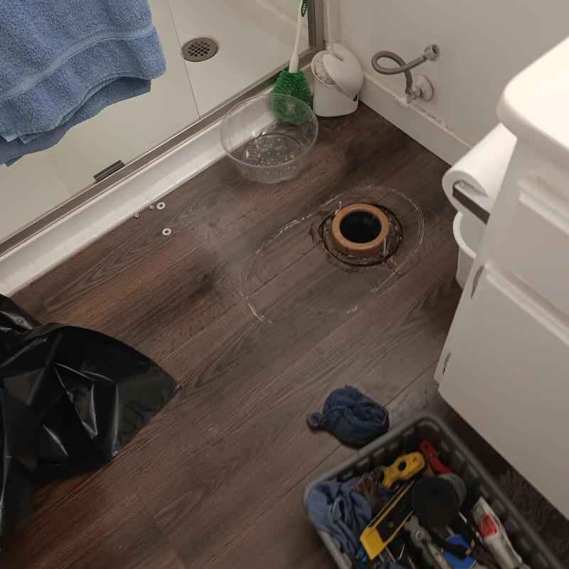 Toilet flange removal on bathroom floor with tools nearby Toilet flange removal on bathroom floor with tools nearby