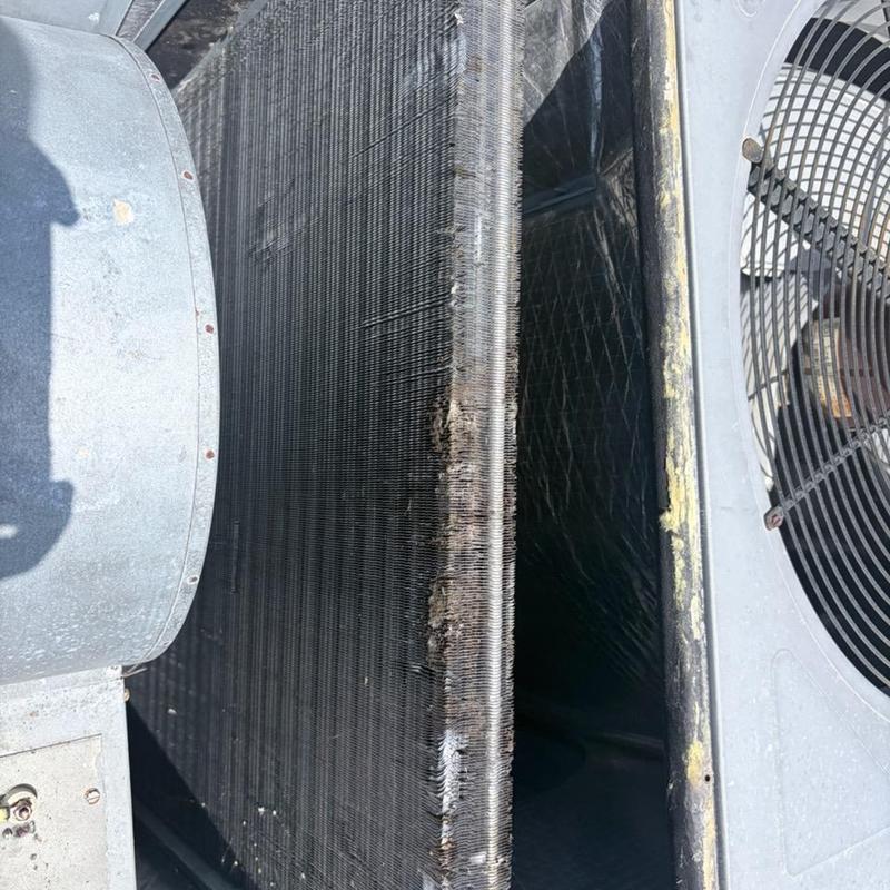 Condenser coil on AC unit clogged with dirt and debris Condenser coil on AC unit clogged with dirt and debris