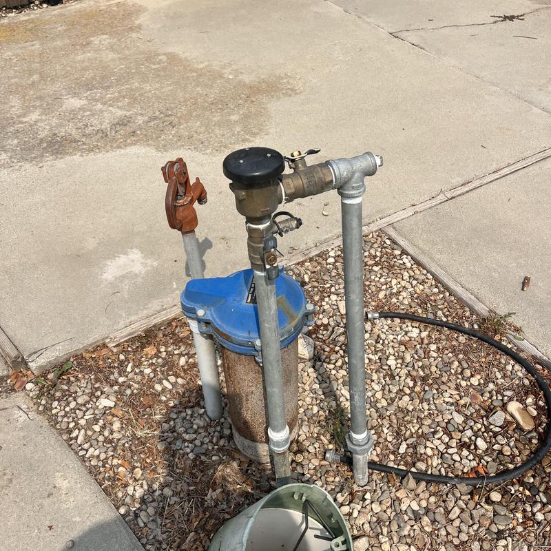 Backflow prevention device with connected piping outdoors Backflow prevention device with connected piping outdoors
