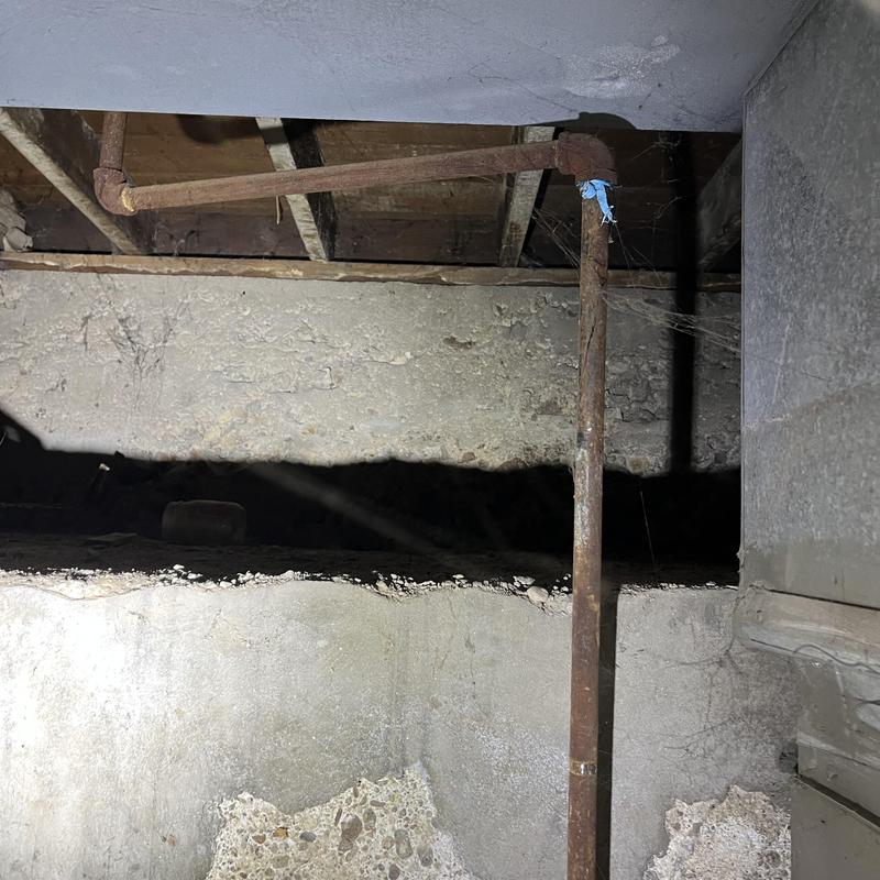 2-inch kitchen drain line in crawlspace with pipe strap