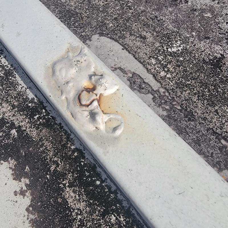 Metal roof panel with deteriorated sealing and rust Metal roof panel with deteriorated sealing and rust