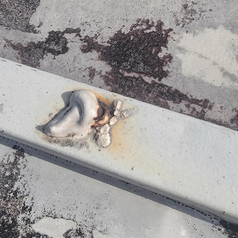 Metal roof screw with deteriorated sealer and rust stain Metal roof screw with deteriorated sealer and rust stain