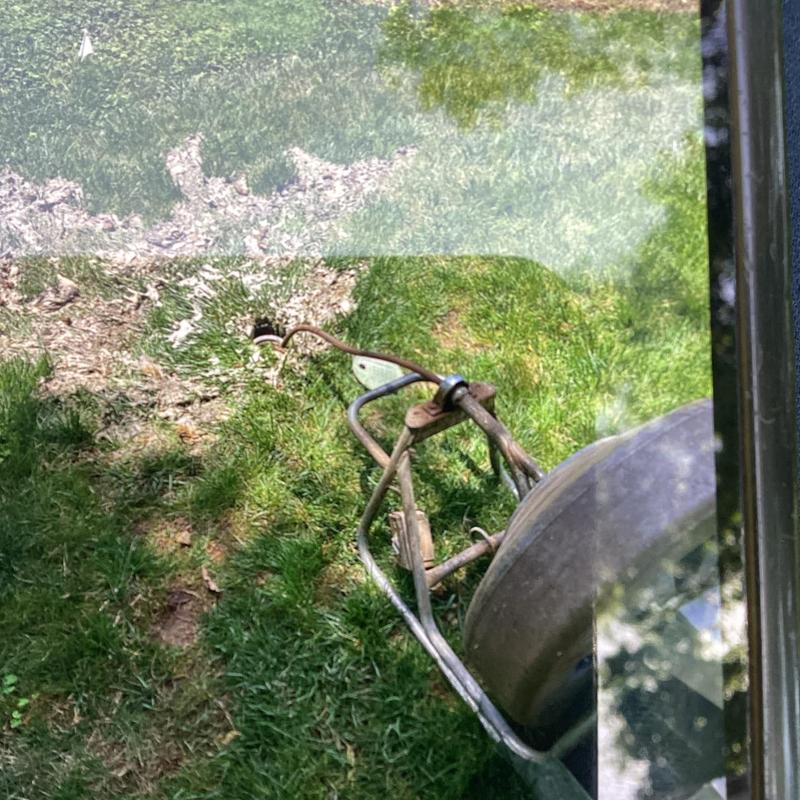 Sewer line drain snake with wheelbarrow on grass