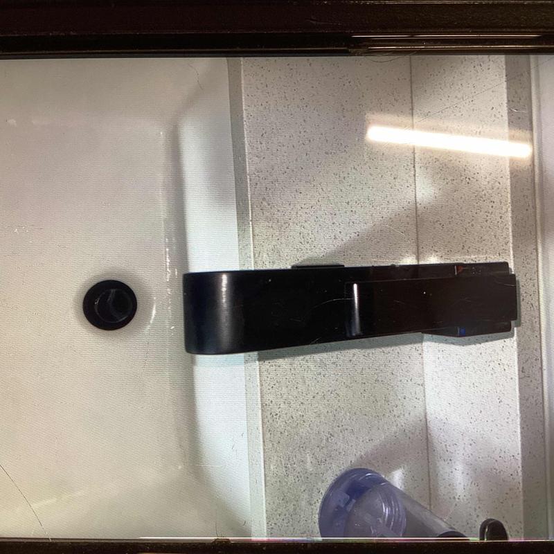 Bathroom faucet handle and sink drain close-up