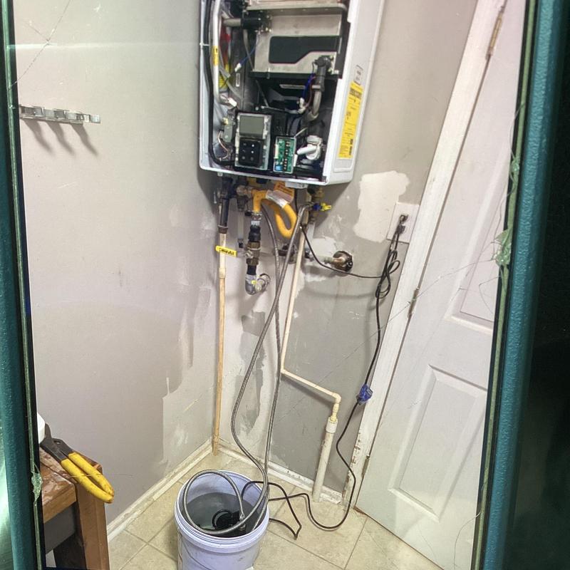 Tankless water heater descaling in utility room