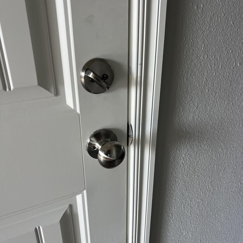 Deadbolt and door knob lock on white door