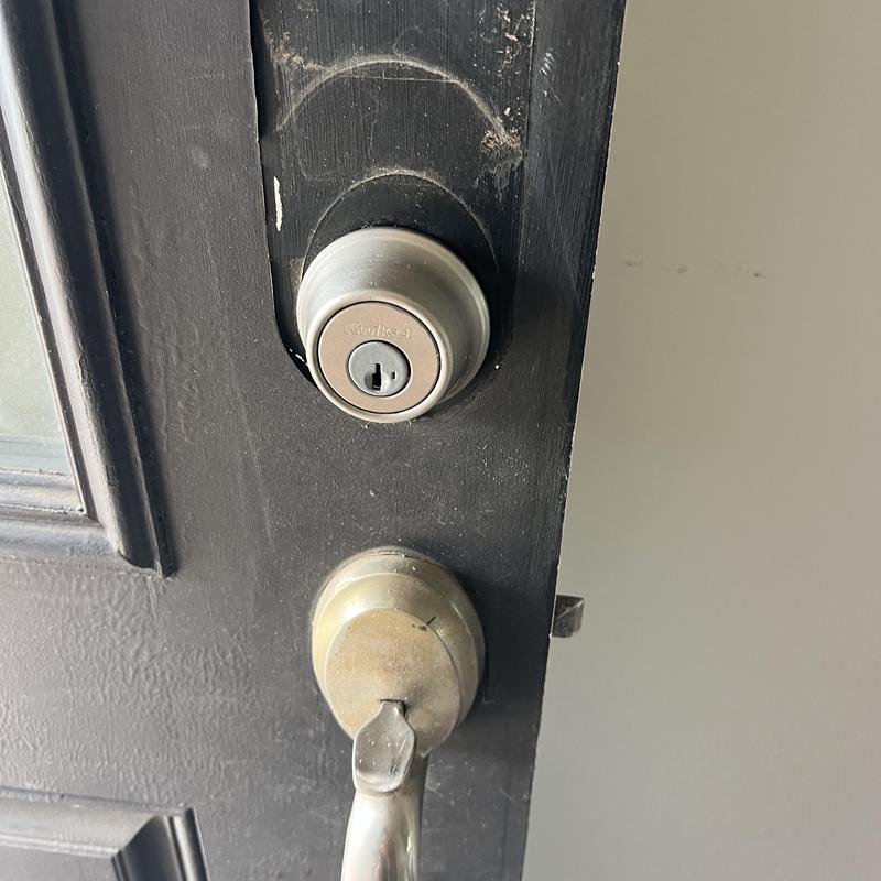 Front door deadbolt and handle lock on black door