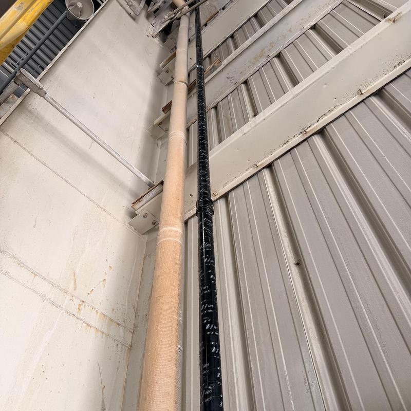 Overhead pressure sewer line with tape wrapping