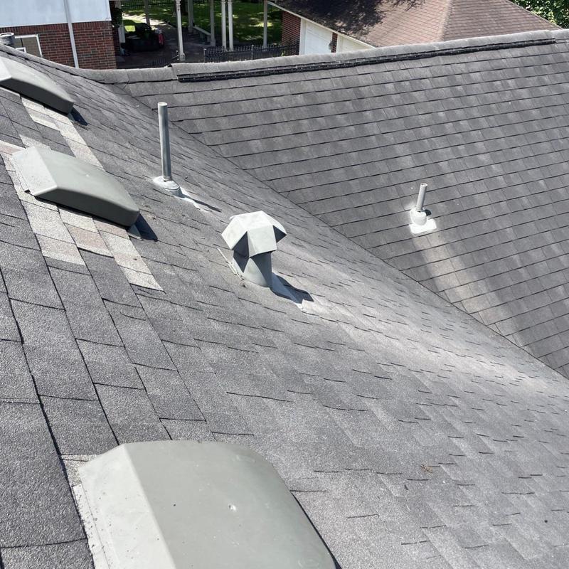 Asphalt shingle roof with repaired ridge cap and vents