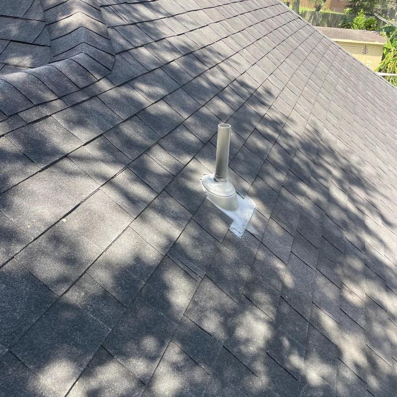 Asphalt shingle roof with vent pipe flashing repair