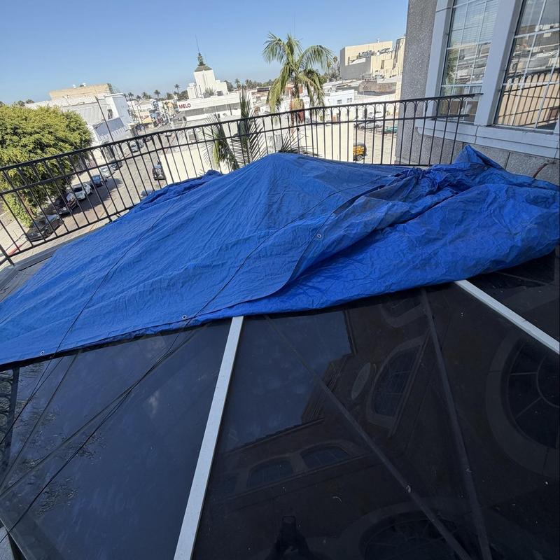 Skylight covered with tarp for leak protection Skylight covered with tarp for leak protection