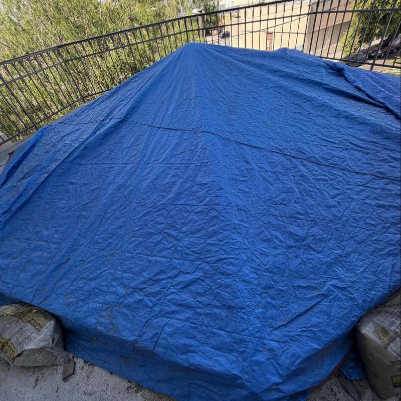 Skylight leak covered with blue tarp and weight bags Skylight leak covered with blue tarp and weight bags
