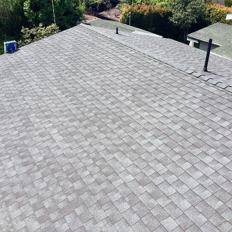 Gray asphalt shingle roof installed on residential home Gray asphalt shingle roof installed on residential home