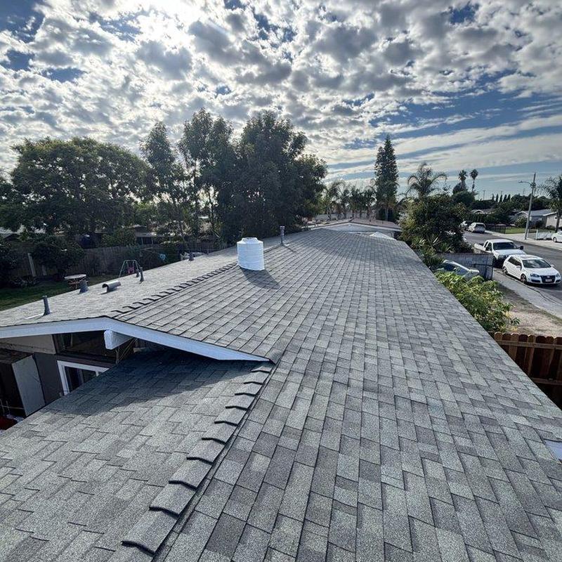 Shingle roof installation on residential home in sunlight Shingle roof installation on residential home in sunlight