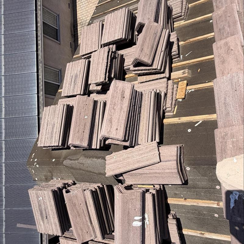 Flat roof tiles stacked for installation on roof Flat roof tiles stacked for installation on roof