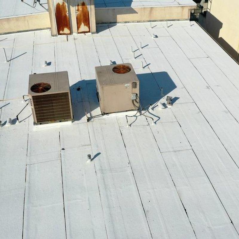 Commercial roof membrane with HVAC units and rust stains Commercial roof membrane with HVAC units and rust stains