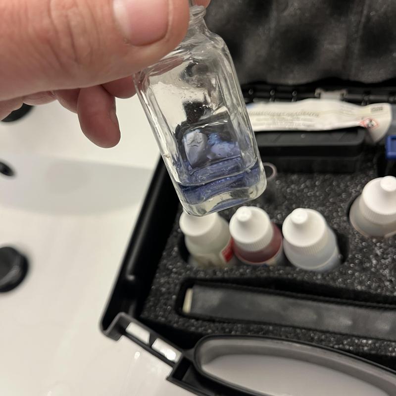 Water softener test solution vial in technician kit