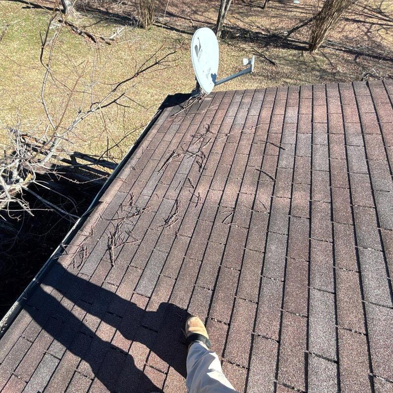 Roof shingles with debris and satellite dish installation