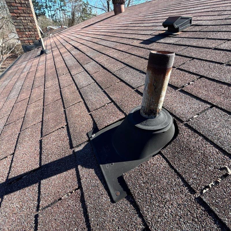Roof vent flashing with rusted pipe on asphalt shingles