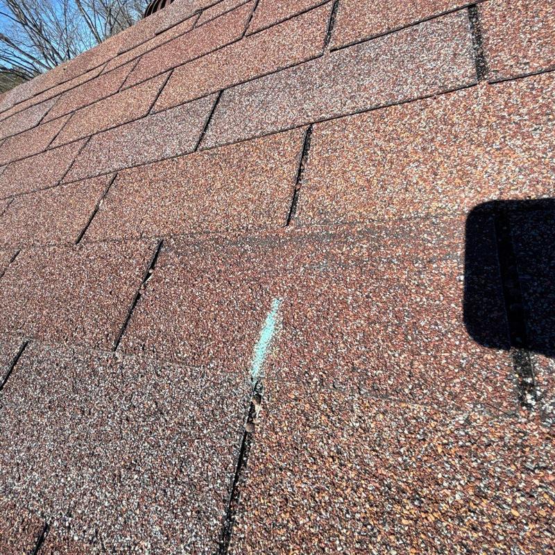 Asphalt Shingles with Hail Damage Marked for Repair