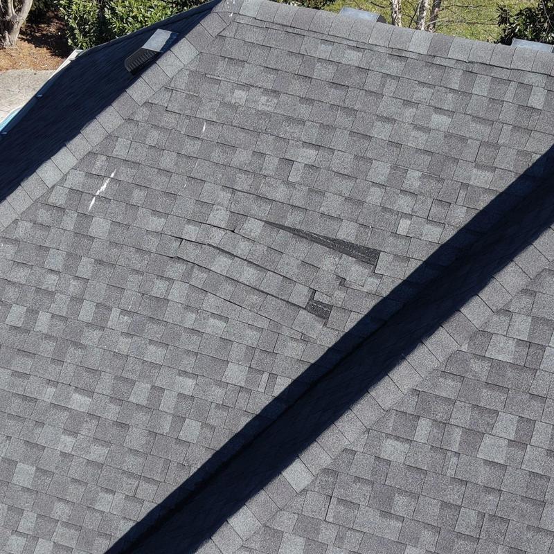 Asphalt shingle roof with visible hail damage and wear