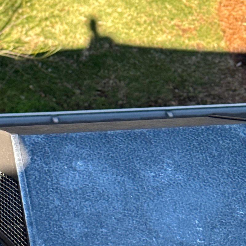 Metal roof panel with visible hail damage spots