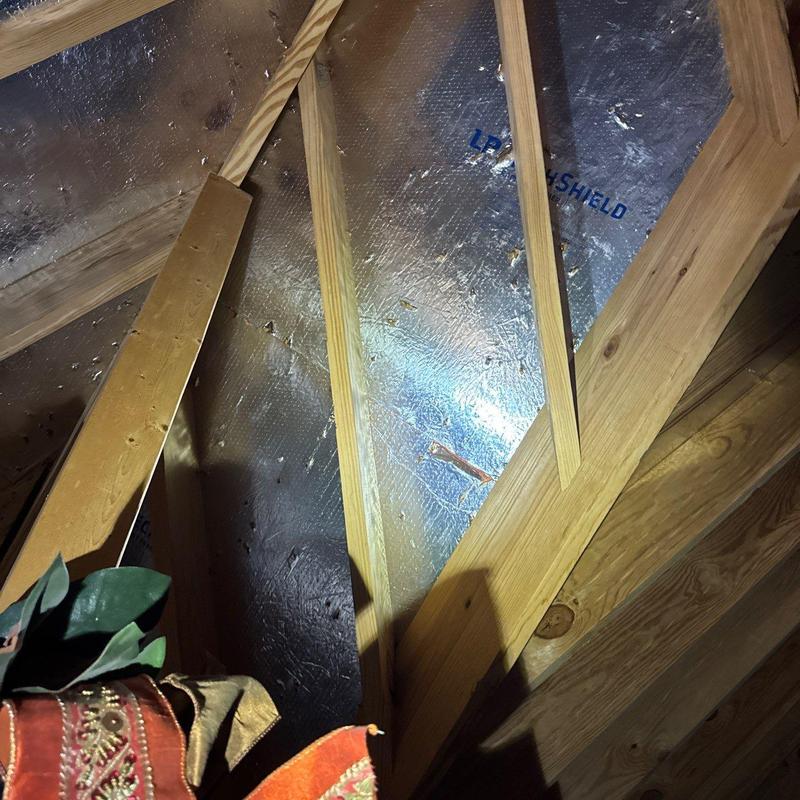 Roof insulation and wooden framing inside attic space