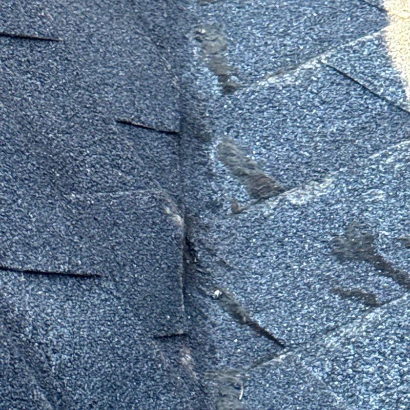Asphalt shingle roof hail damage close-up detail