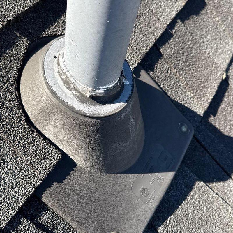 Roof pipe flashing on asphalt shingle roof with sealant