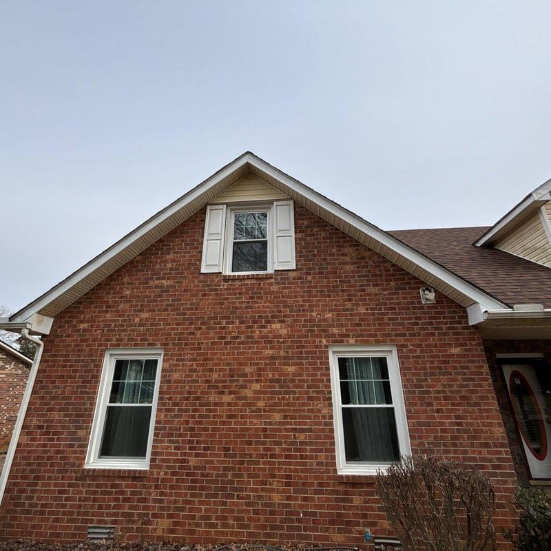 Brick exterior wall with windows and roofline