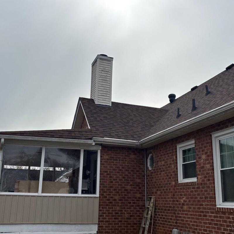 Asphalt shingle roof with chimney and gutters
