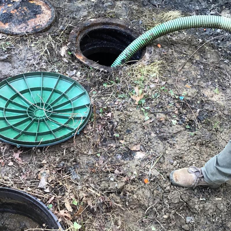 Septic tank with pump hose and green lid removed