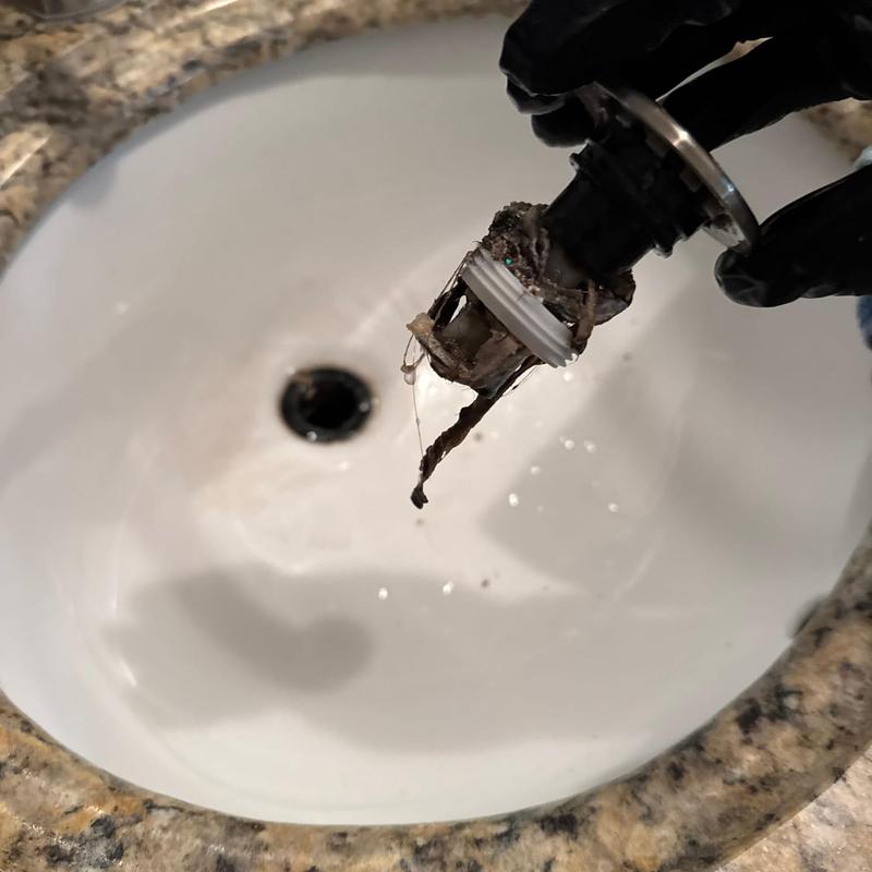 Bathroom sink drain trap with hair buildup removed
