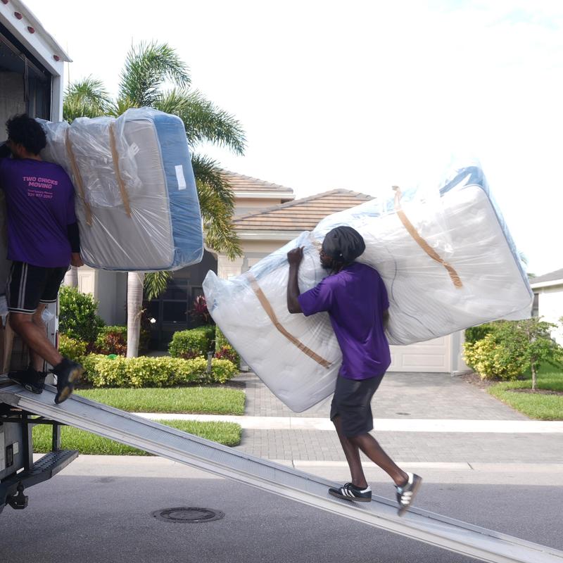 Mattress moving into a moving truck in residential area Mattress moving into a moving truck in residential area