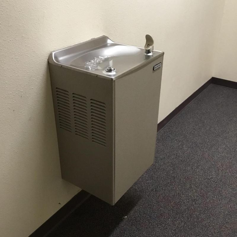 Drinking fountain installed along office wall Drinking fountain installed along office wall