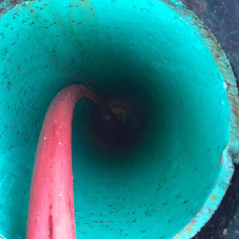 Drain pipe interior with hydro jet hose inserted