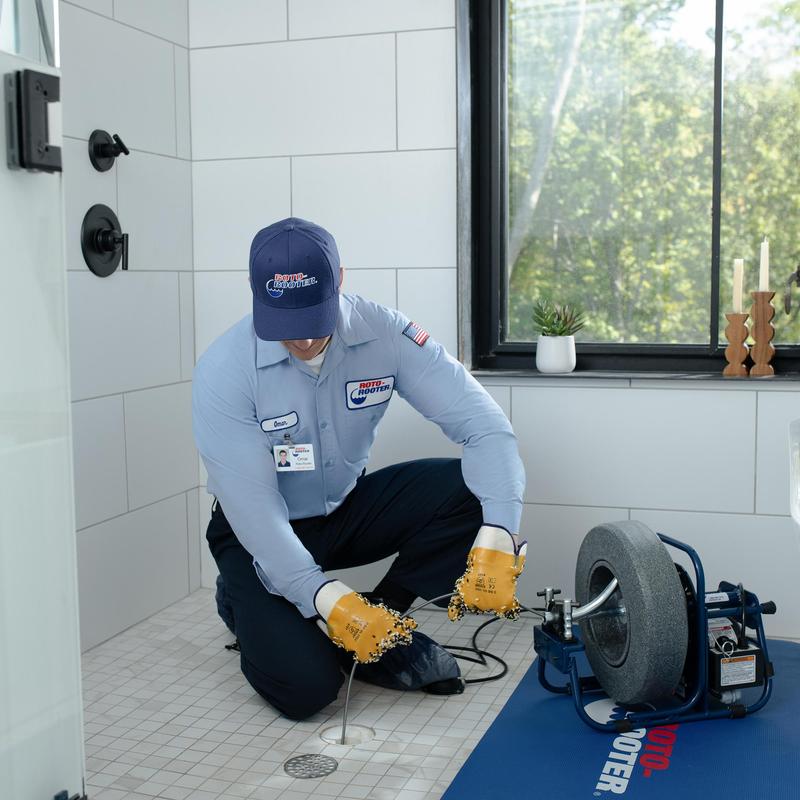 Tiled shower floor drain clearing with powered auger Tiled shower floor drain clearing with powered auger