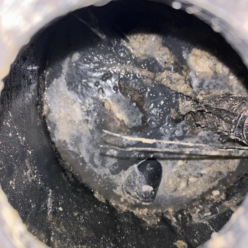 Sump pump basin with debris inside during diagnosis Sump pump basin with debris inside during diagnosis