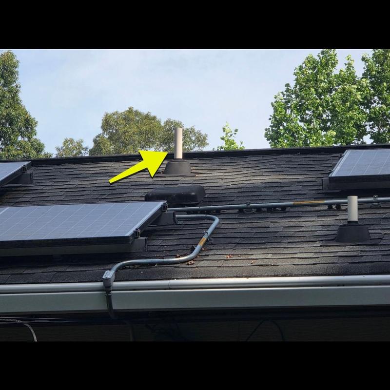 Solar panel array on shingle roof with pipe flashing