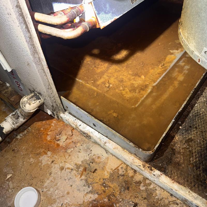 Heat pump drain pan with rust and water buildup