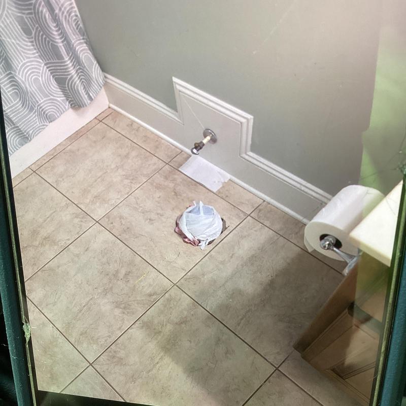 Bathroom toilet drain capped with supply valve visible