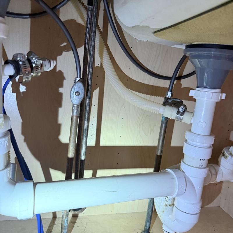 Laundry valve and kitchen faucet plumbing installation under sink