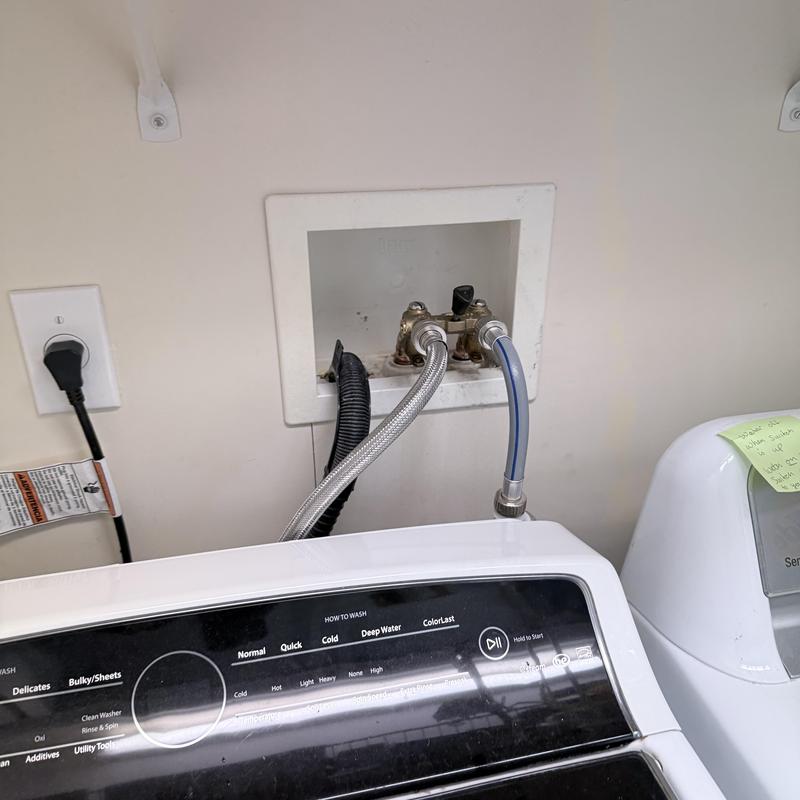 Laundry valve box with water supply hoses installed