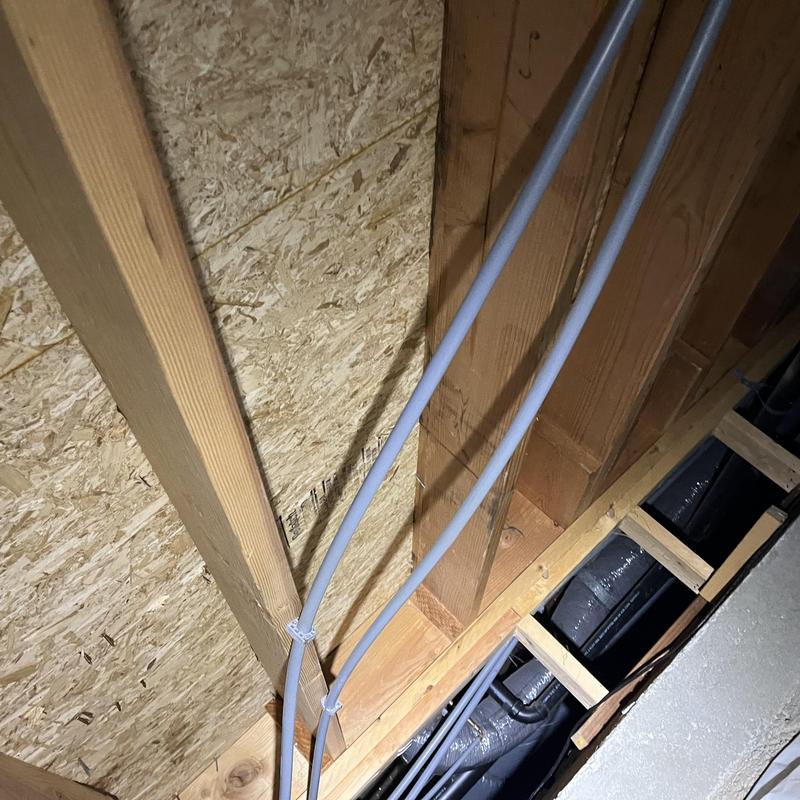 PEX water piping installation in wooden framing cavity