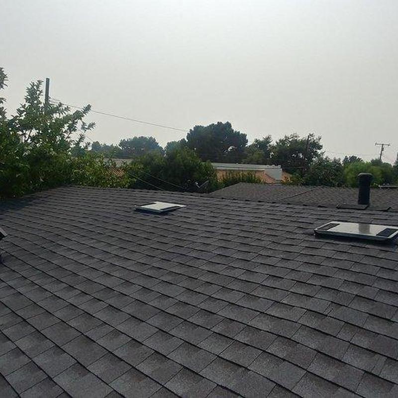 Shingle roof with skylights installation on residential home Shingle roof with skylights installation on residential home