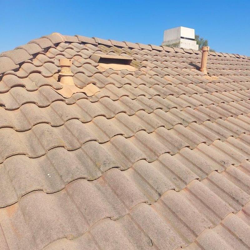 Tile roof surface with vent pipes and chimney inspection Tile roof surface with vent pipes and chimney inspection