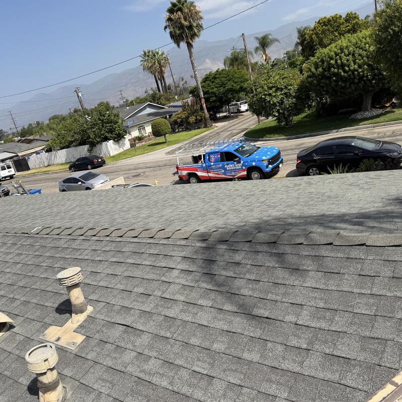Shingle roof with plumbing vents and roof inspection truck Shingle roof with plumbing vents and roof inspection truck
